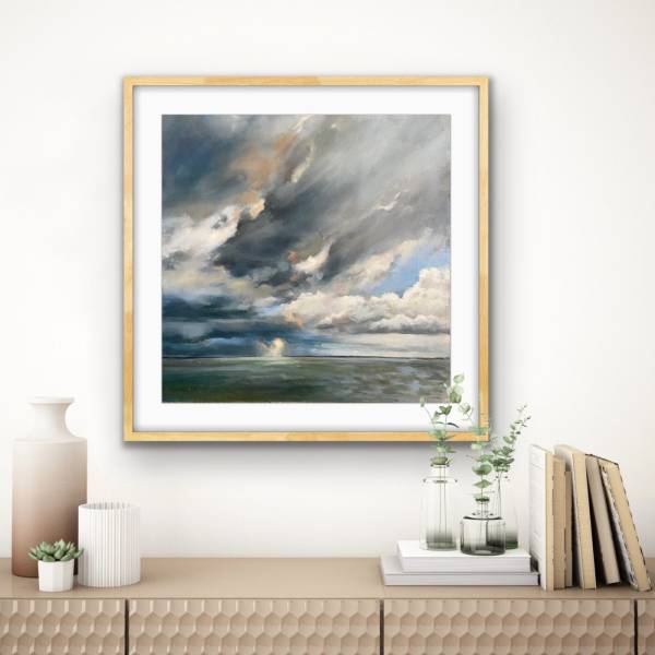 Serene coastal landscape with dramatic clouds.